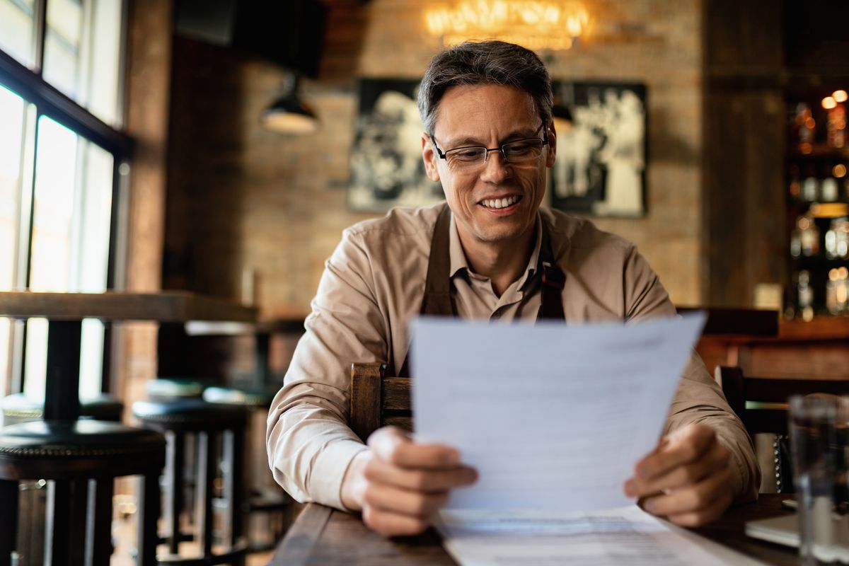 Business owner reviewing benefits documents
